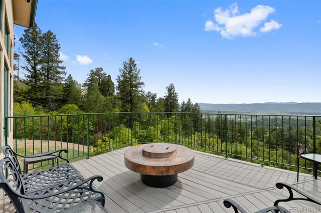 a view of a roof deck with wooden floor and fence
