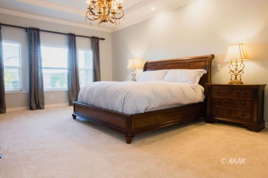 430 West Javis Avenue Ridgecrest, CA 93555 - Photo 19 of 35 a bed sitting in a spacious bedroom next to a window