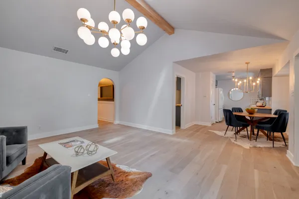 a view of a room with furniture and wooden floor