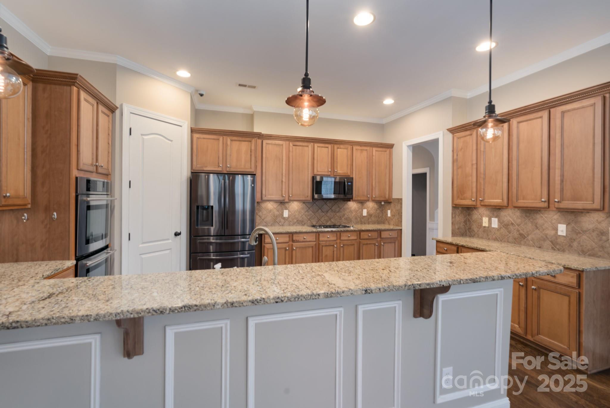 507 Quicksilver Trail Fort Mill, SC 29708 - Photo 12 of 48 a kitchen with stainless steel appliances granite countertop a sink refrigerator and cabinets