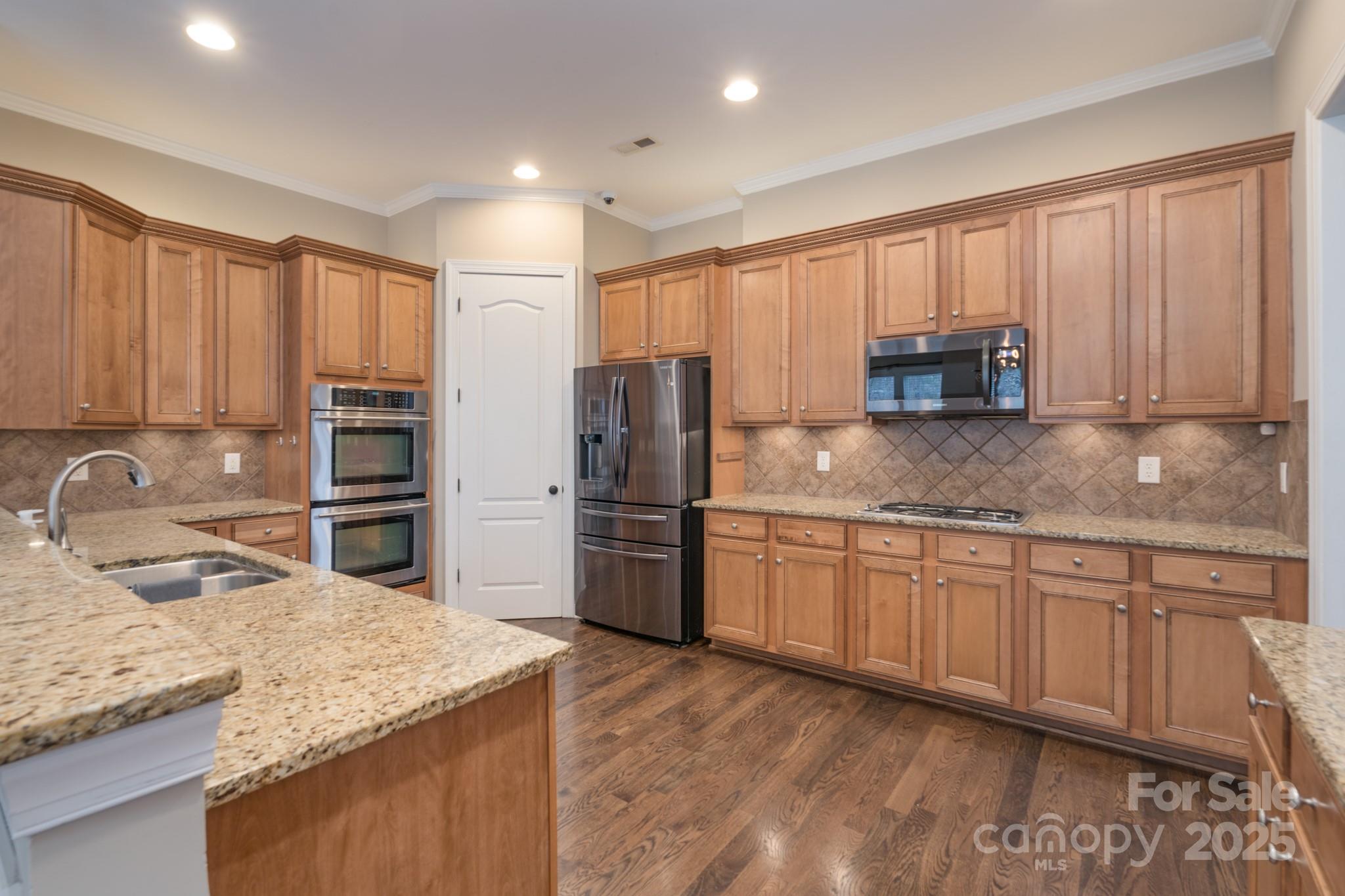 507 Quicksilver Trail Fort Mill, SC 29708 - Photo 13 of 48 a kitchen with stainless steel appliances granite countertop a sink refrigerator and cabinets