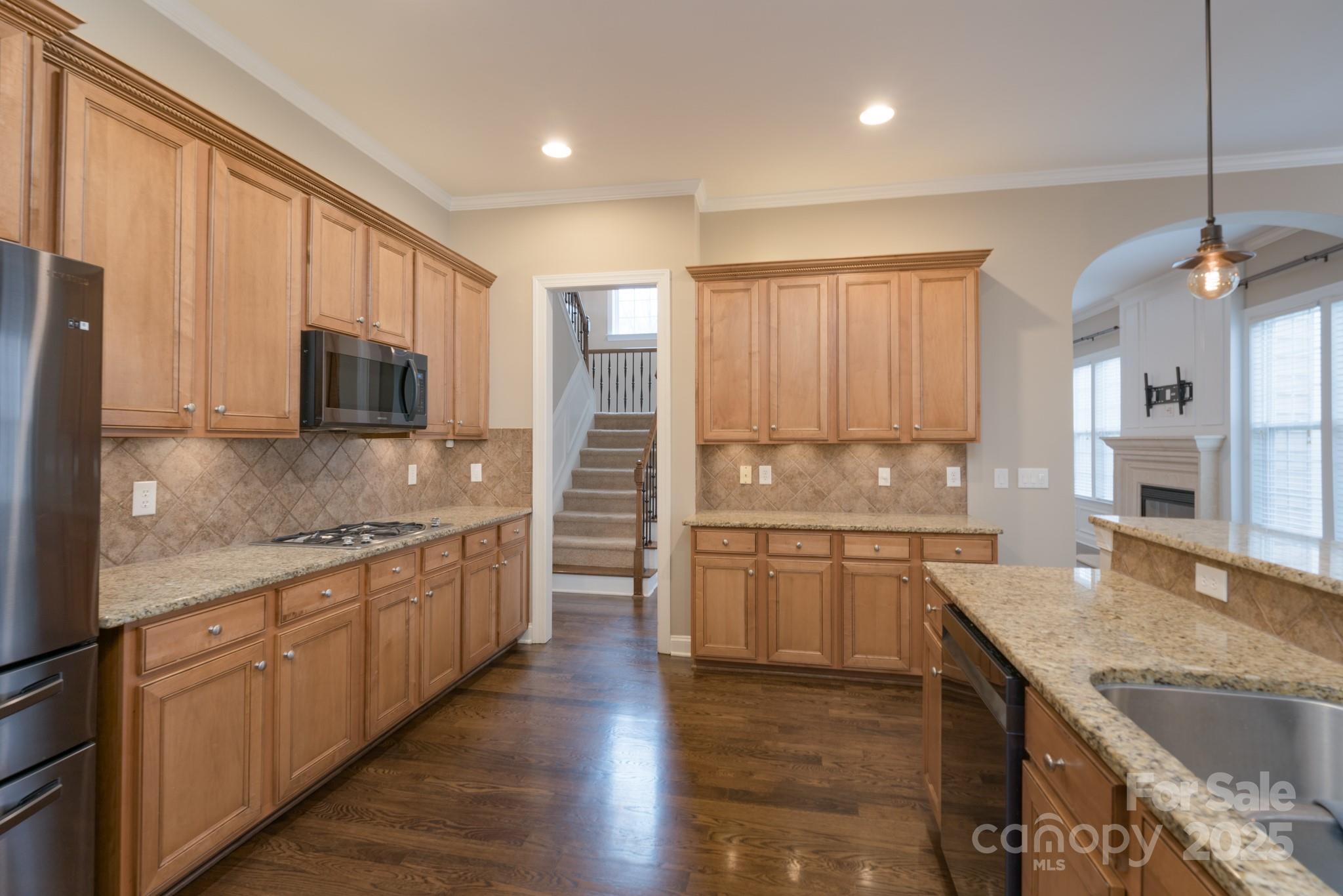 507 Quicksilver Trail Fort Mill, SC 29708 - Photo 14 of 48 a kitchen with granite countertop sink stainless steel appliances and cabinets