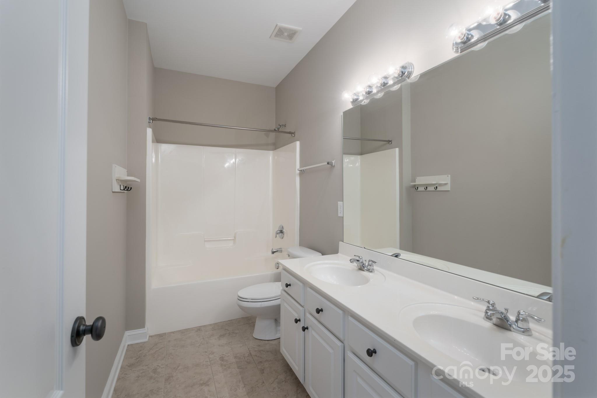 507 Quicksilver Trail Fort Mill, SC 29708 - Photo 24 of 48 a spacious bathroom with a double vanity sink a toilet and a mirror