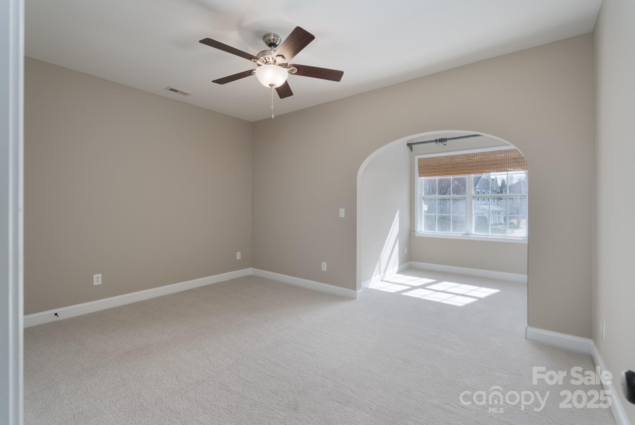 507 Quicksilver Trail Fort Mill, SC 29708 - Photo 25 of 48 an empty room with windows and fan