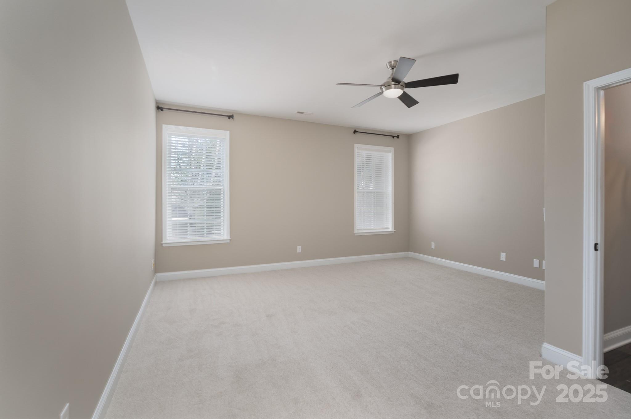 507 Quicksilver Trail Fort Mill, SC 29708 - Photo 30 of 48 an empty room with windows and fan