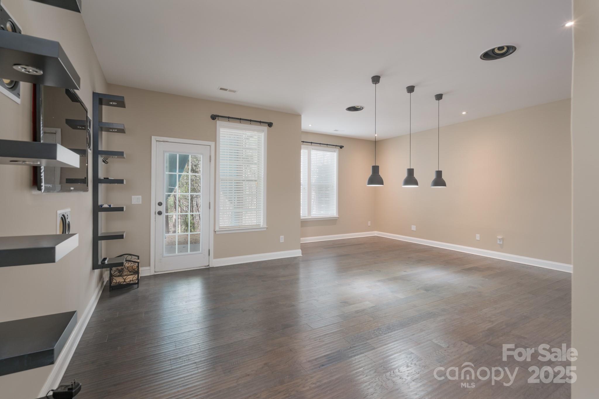507 Quicksilver Trail Fort Mill, SC 29708 - Photo 32 of 48 an empty room with wooden floor and windows