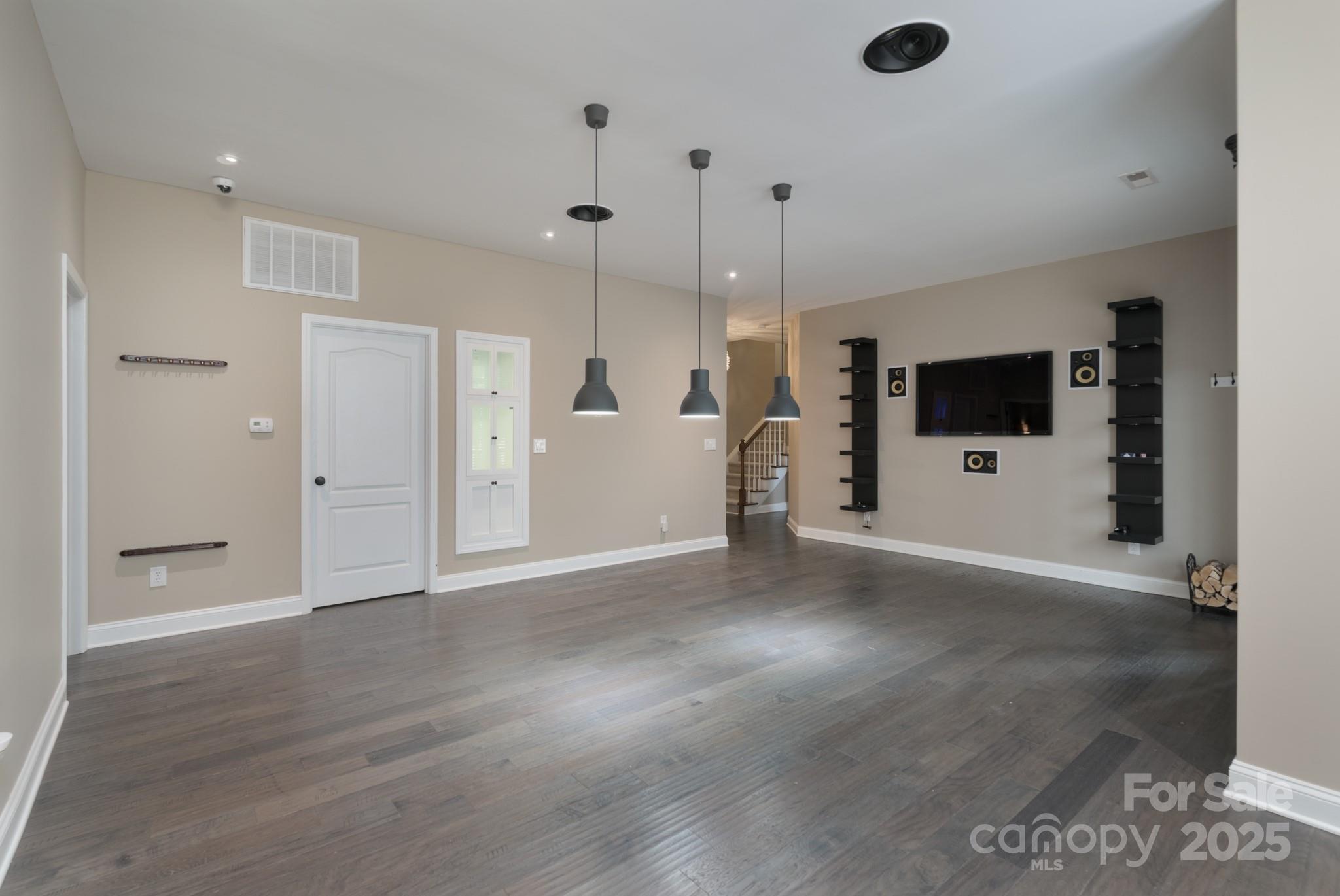 507 Quicksilver Trail Fort Mill, SC 29708 - Photo 34 of 48 a view of an empty room with wooden floor and a ceiling fan