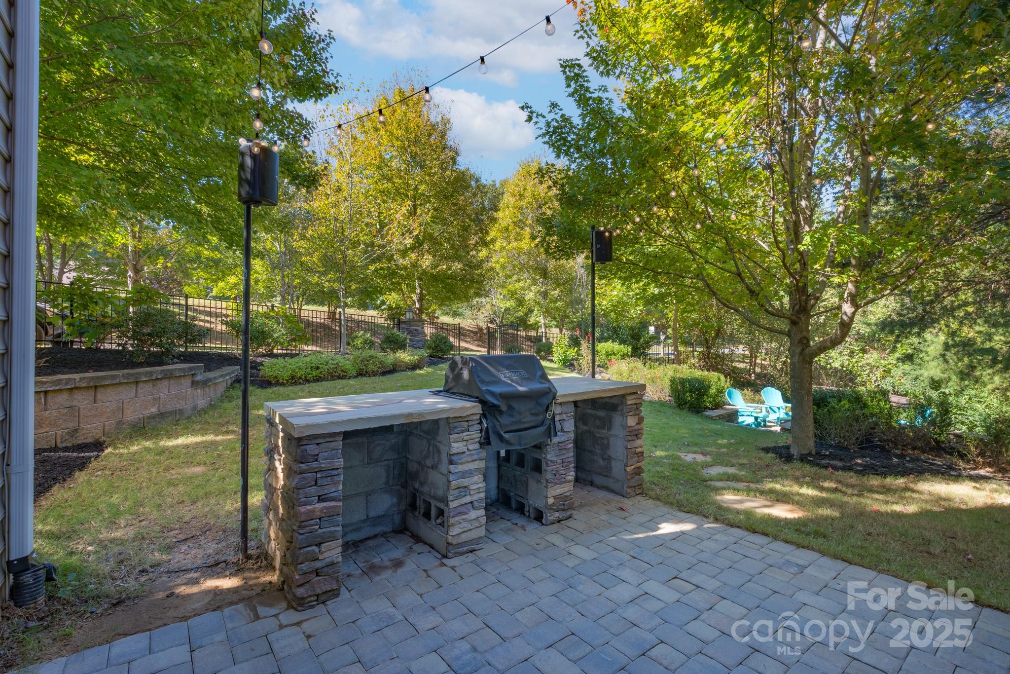 507 Quicksilver Trail Fort Mill, SC 29708 - Photo 42 of 48 a view of a patio with table and chairs potted plants and large tree