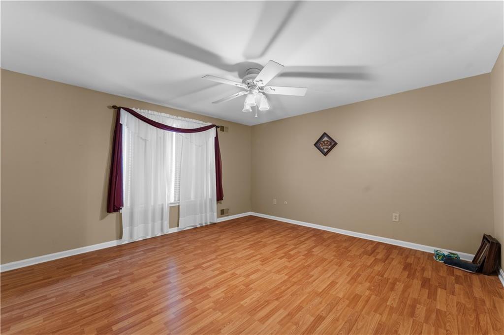 1033 Rutledge Drive Pittsburgh, PA 15241 - Photo 18 of 32 a view of a room with a ceiling fan and wooden floor