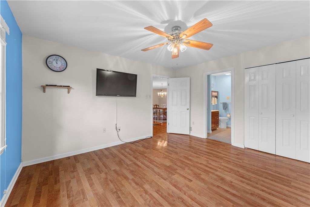 1033 Rutledge Drive Pittsburgh, PA 15241 - Photo 22 of 32 a view of a livingroom with wooden floor and a ceiling fan