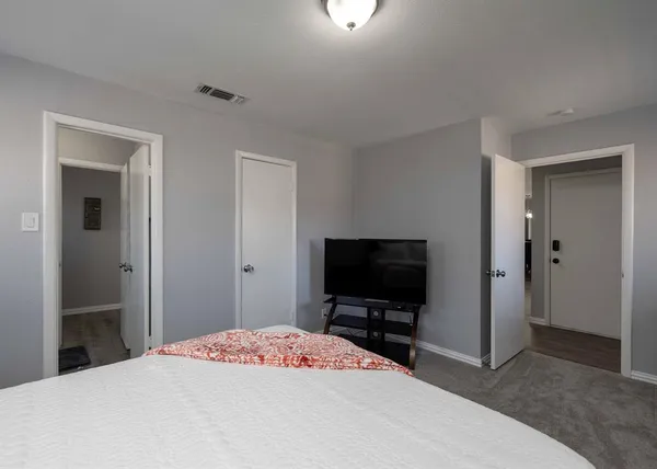 a bedroom with a bed and a flat screen tv