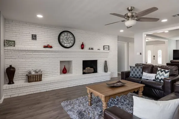 a living room with furniture a clock and a fireplace