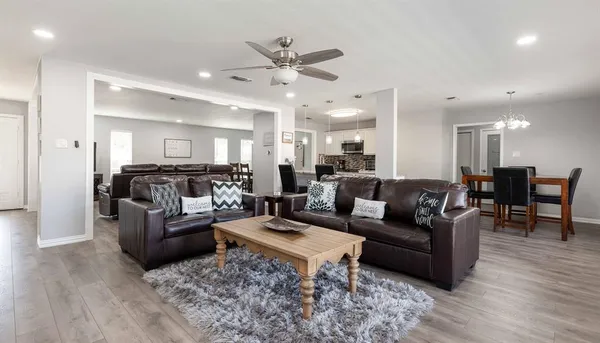 a living room with furniture and wooden floor