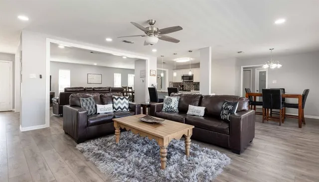 a living room with furniture and wooden floor