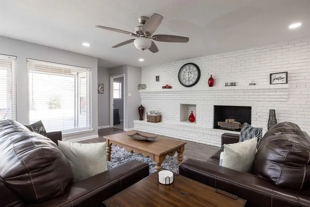 a living room with furniture and a fireplace
