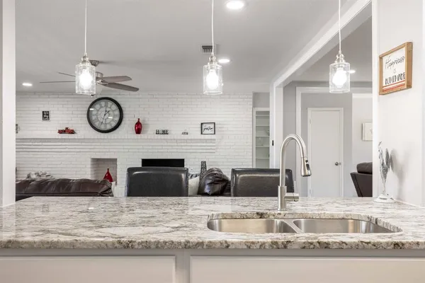 a kitchen with stainless steel appliances granite countertop a stove and a microwave