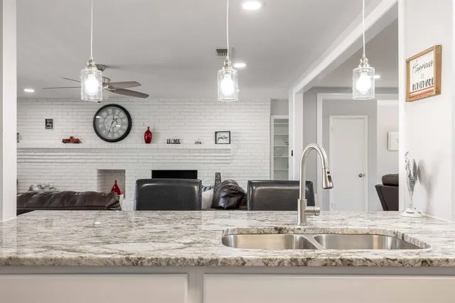 a kitchen with stainless steel appliances granite countertop a stove and a microwave
