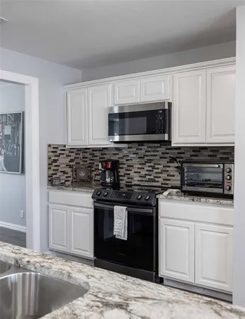 a view of a kitchen with kitchen island and a chandelier