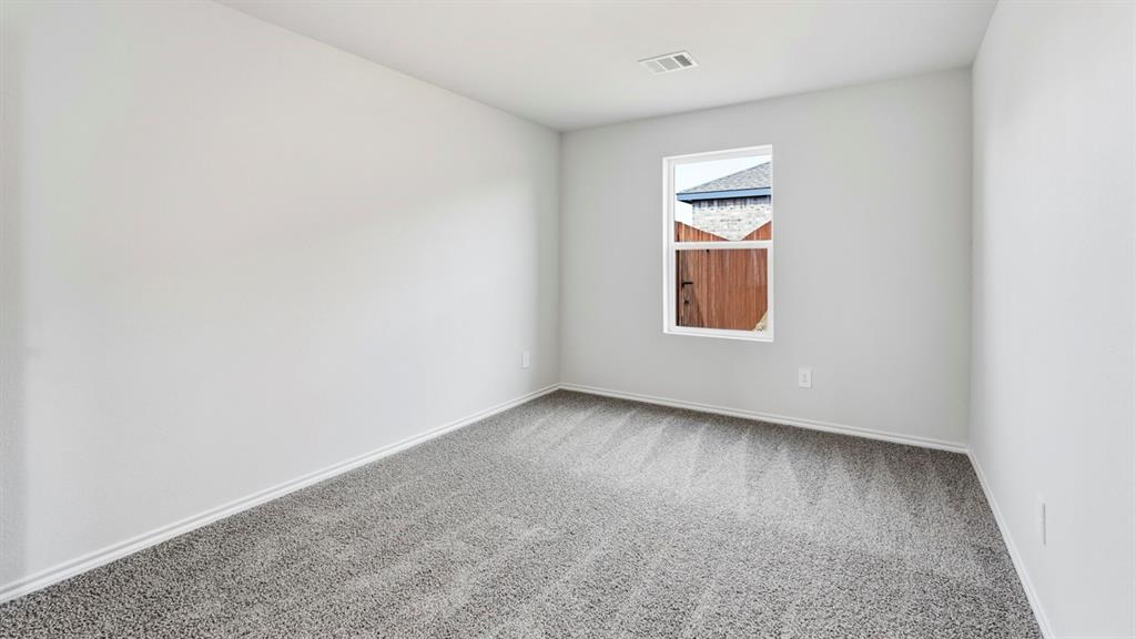 3535 Spring Time Street Forney, TX 75126 - Photo 12 of 23 Room featuring light gray wall paint, white trim, and gray patterned carpeting