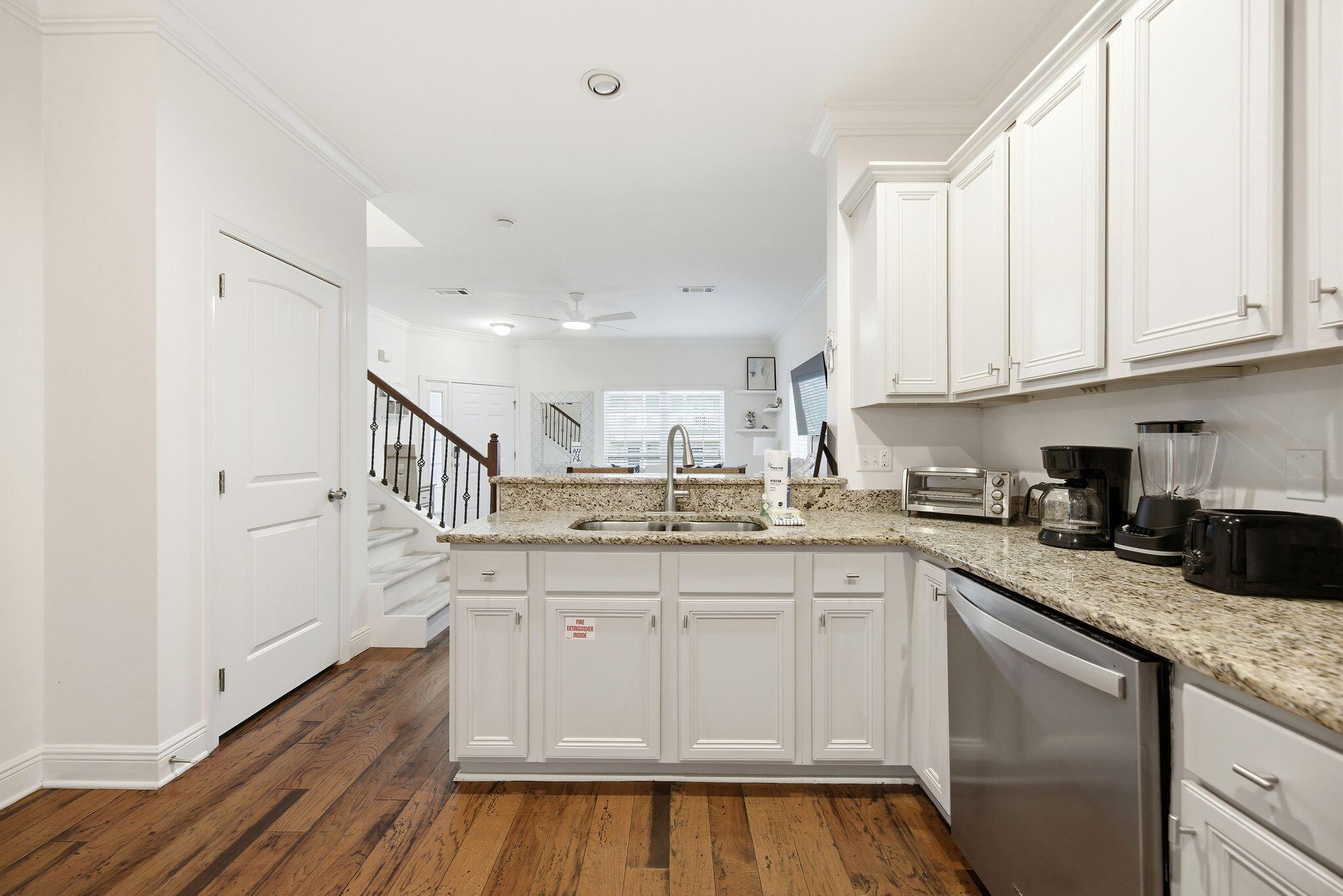 54 West Shore Place Inlet Beach, FL 32461 - Photo 11 of 38 a kitchen with granite countertop white cabinets and white appliances