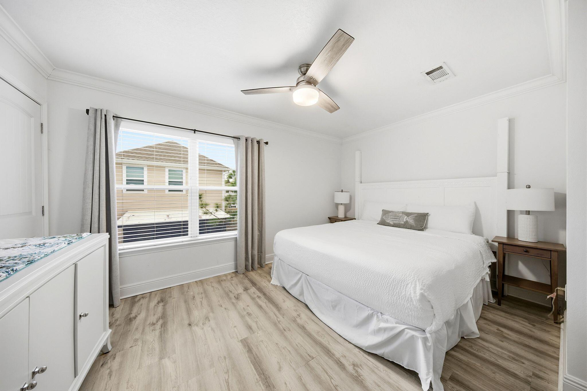 54 West Shore Place Inlet Beach, FL 32461 - Photo 17 of 38 a bedroom with a large bed and a wooden floor