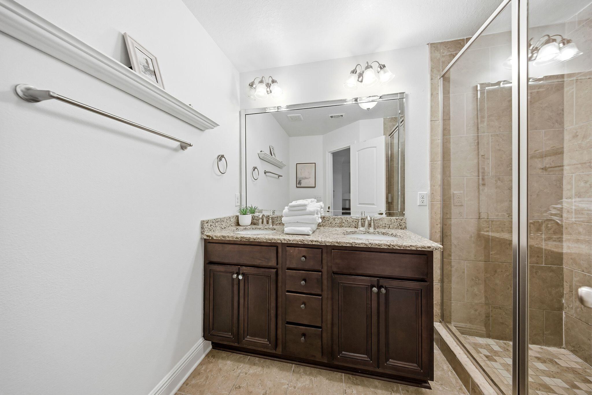 54 West Shore Place Inlet Beach, FL 32461 - Photo 20 of 38 a bathroom with a granite countertop sink a large mirror and a shower