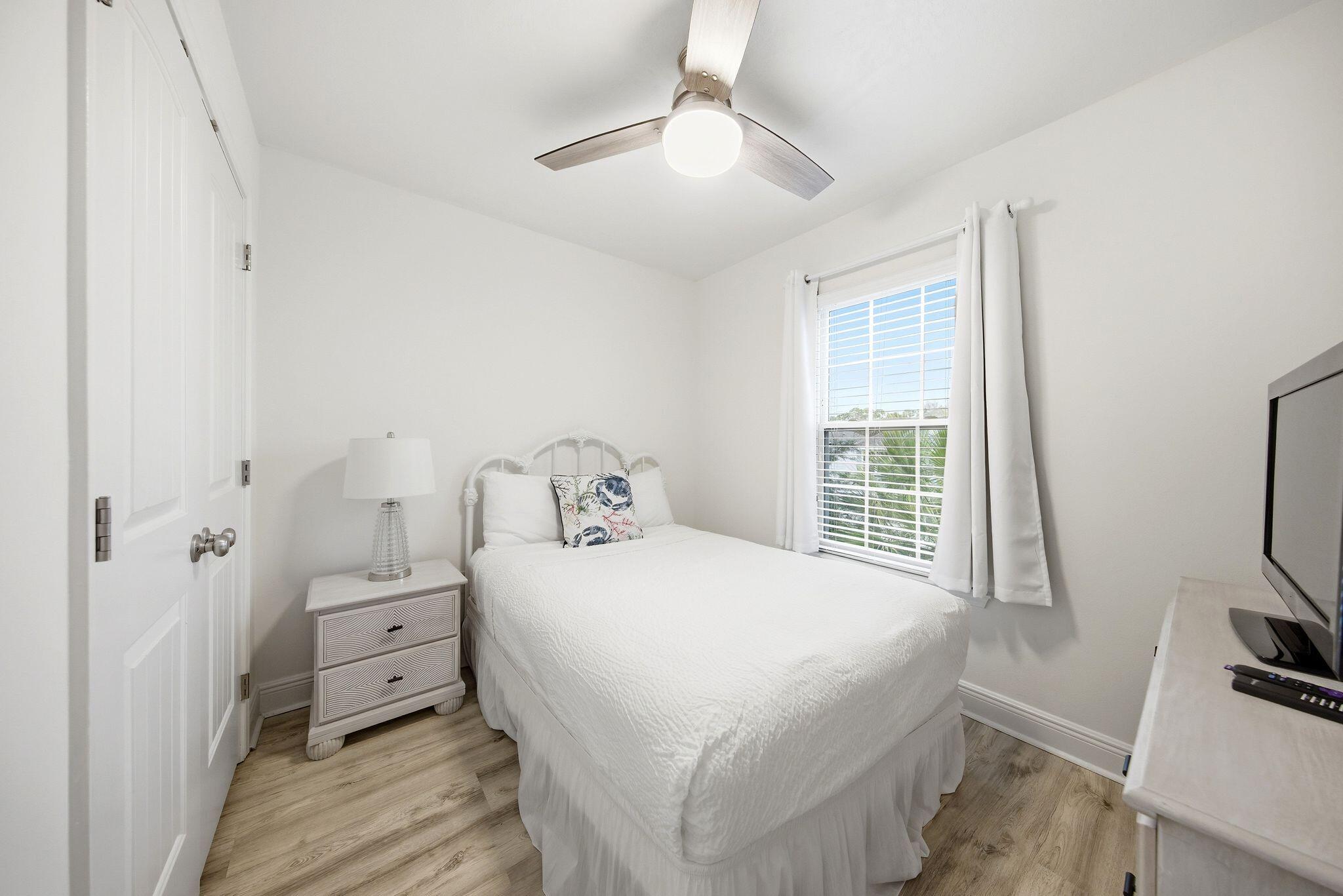 54 West Shore Place Inlet Beach, FL 32461 - Photo 25 of 38 a bedroom with a bed and a flat tv screen on dresser