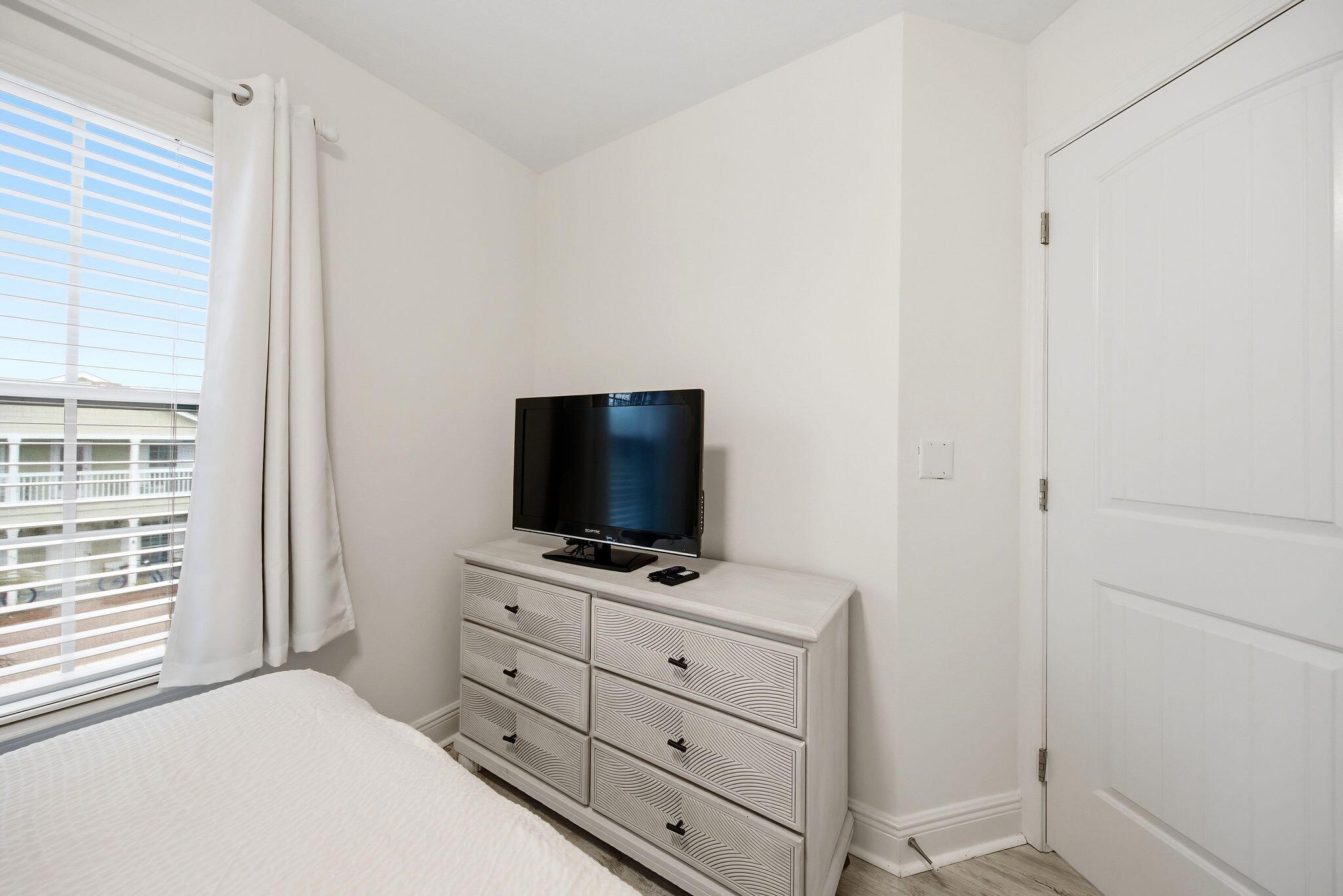 54 West Shore Place Inlet Beach, FL 32461 - Photo 26 of 38 a bedroom with a bed and a flat screen tv