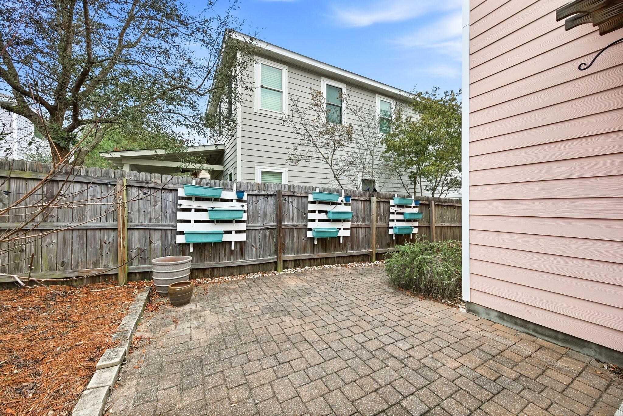 54 West Shore Place Inlet Beach, FL 32461 - Photo 31 of 38 a backyard of a house with barbeque oven table and chairs