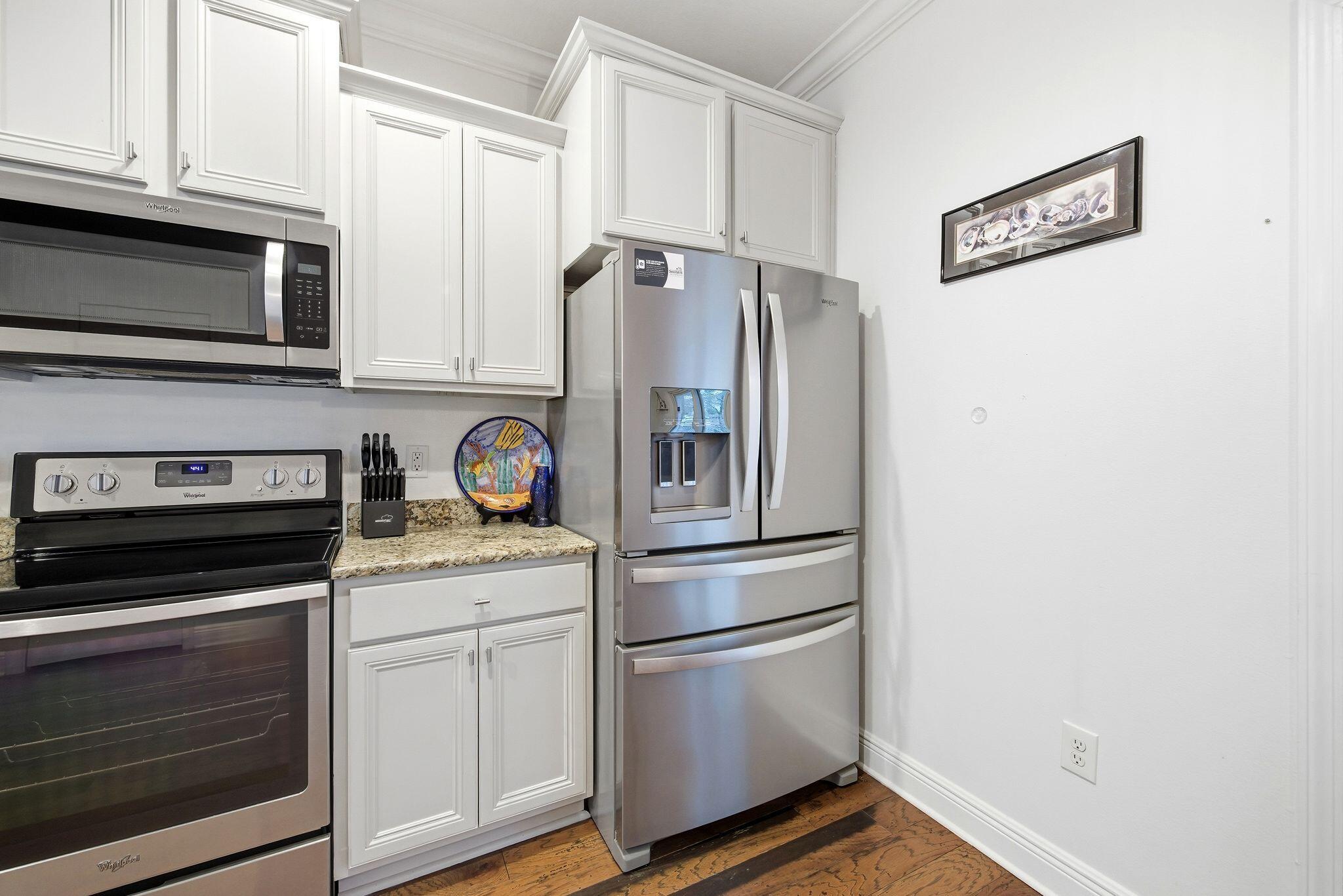 54 West Shore Place Inlet Beach, FL 32461 - Photo 10 of 38 a kitchen with stainless steel appliances white cabinets and a stove