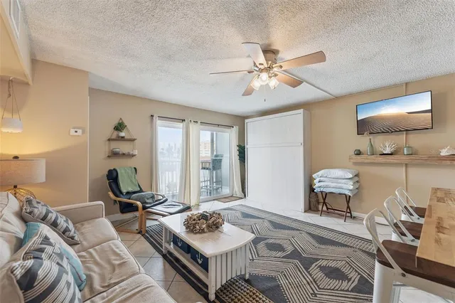 a living room with furniture and a large window with garden view