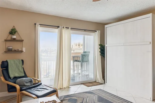 a living room with furniture and a kitchen view