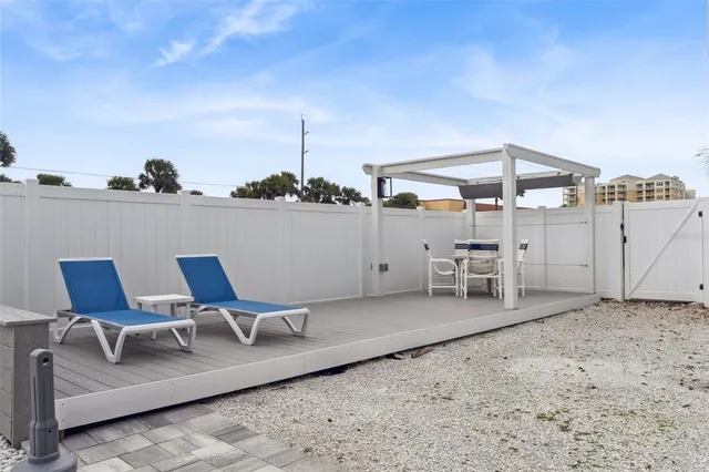 a view of a swimming pool with outdoor seating