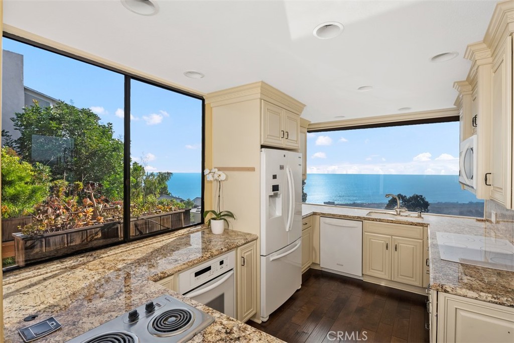 1339 La Mirada Street Laguna Beach, CA 92651 - Photo 11 of 28 a kitchen with stainless steel appliances a stove and a refrigerator