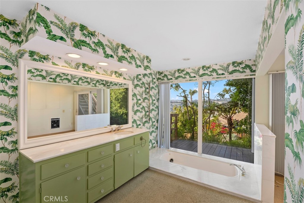 1339 La Mirada Street Laguna Beach, CA 92651 - Photo 17 of 28 a bathroom with a large mirror vanity and a shower
