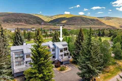 an aerial view of a house with a yard and outdoor seating