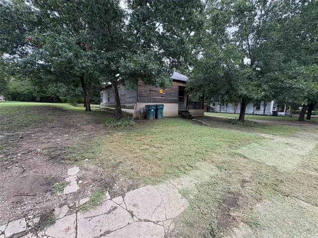 a view of a yard with a house and a tree