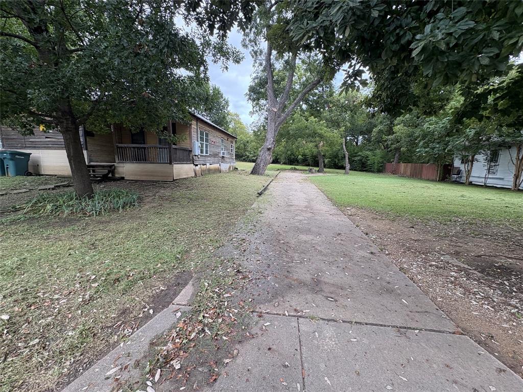625 South Rusk Street Sherman, TX 75090 - Photo 4 of 19 a view of house with backyard and trees