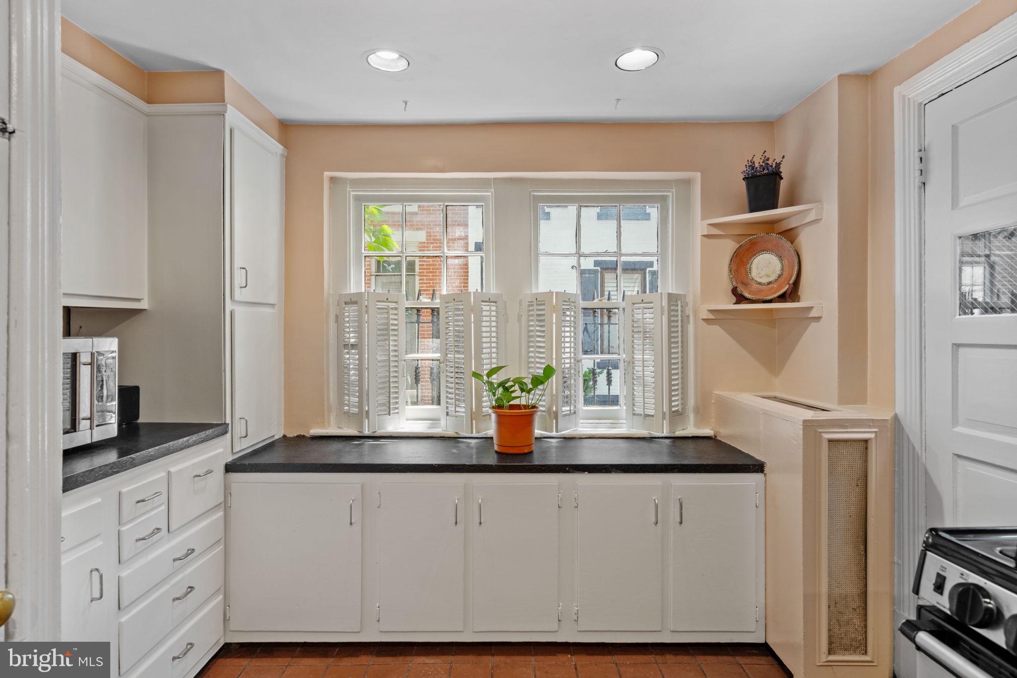 2208 Rittenhouse Square Philadelphia, PA 19103 - Photo 11 of 27 a kitchen with white cabinets and window