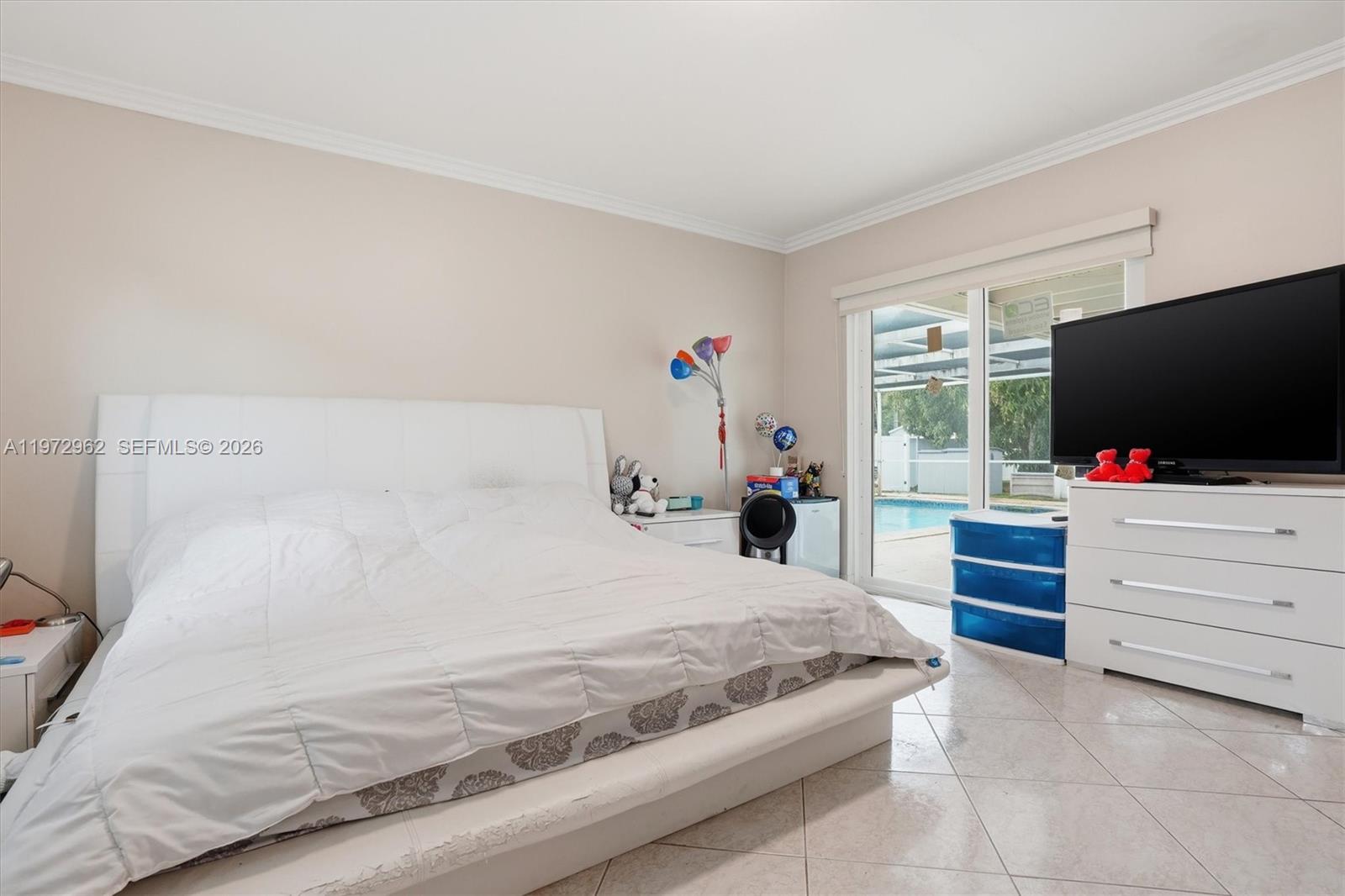 5518 McKinley Street Hollywood, FL 33021 - Photo 12 of 21 a bedroom with a bed and a flat screen tv