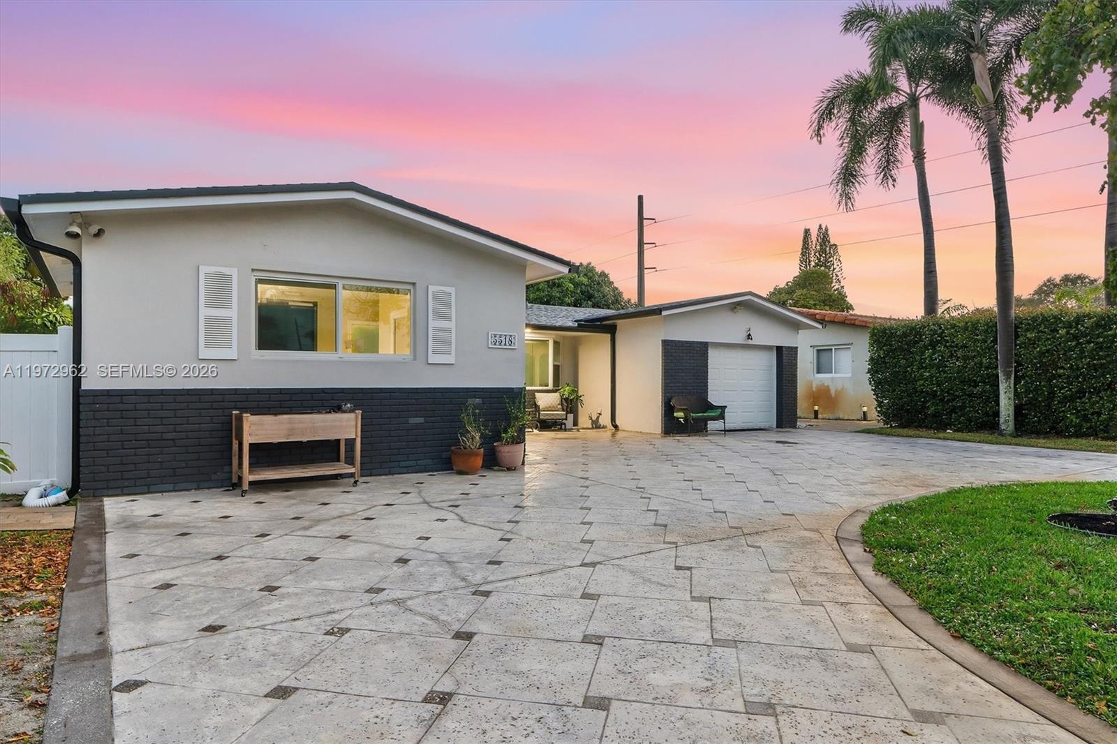 5518 McKinley Street Hollywood, FL 33021 - Photo 17 of 21 a front view of a house with a yard and garage