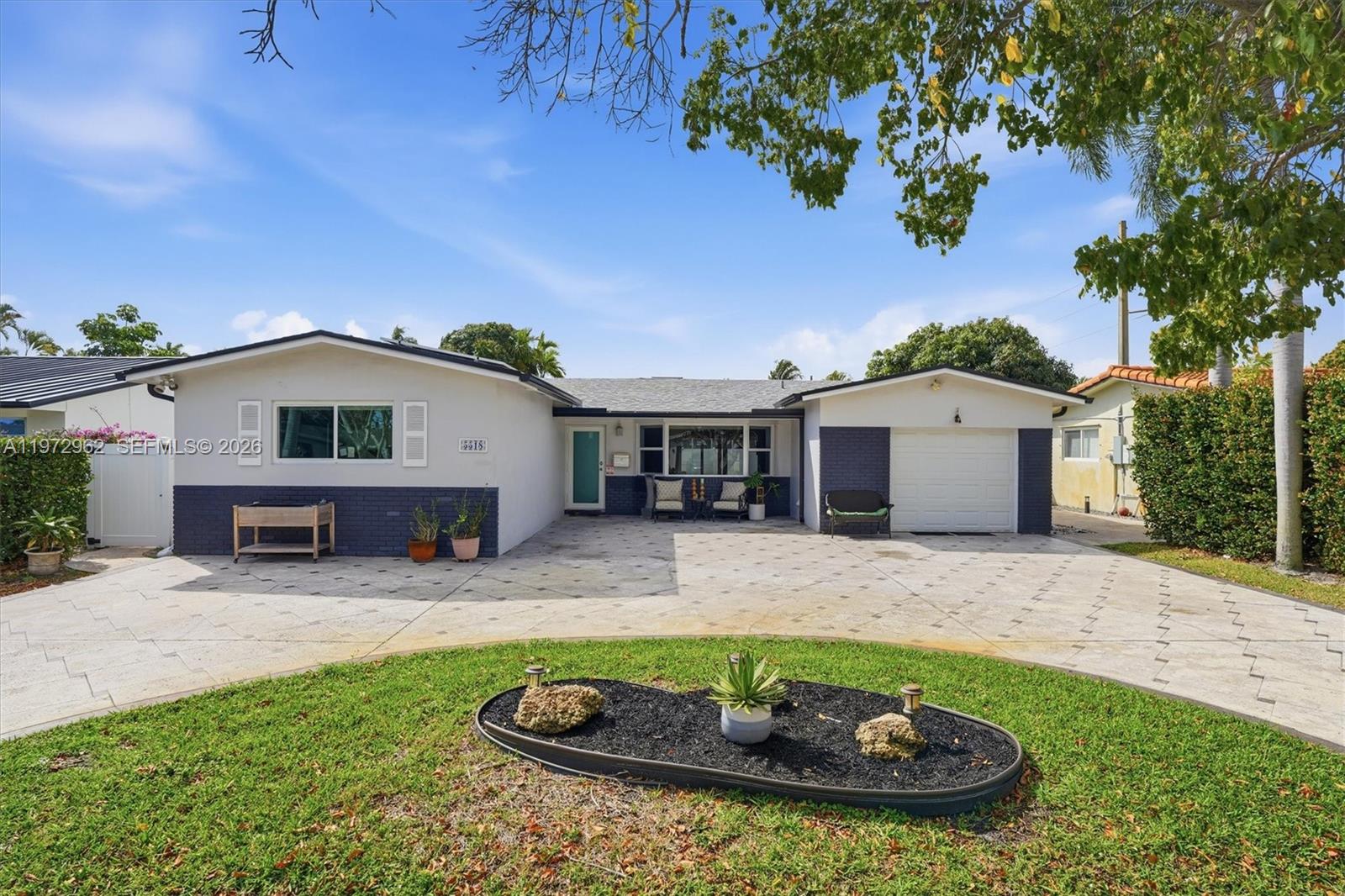 5518 McKinley Street Hollywood, FL 33021 - Photo 2 of 21 a front view of a house with garden