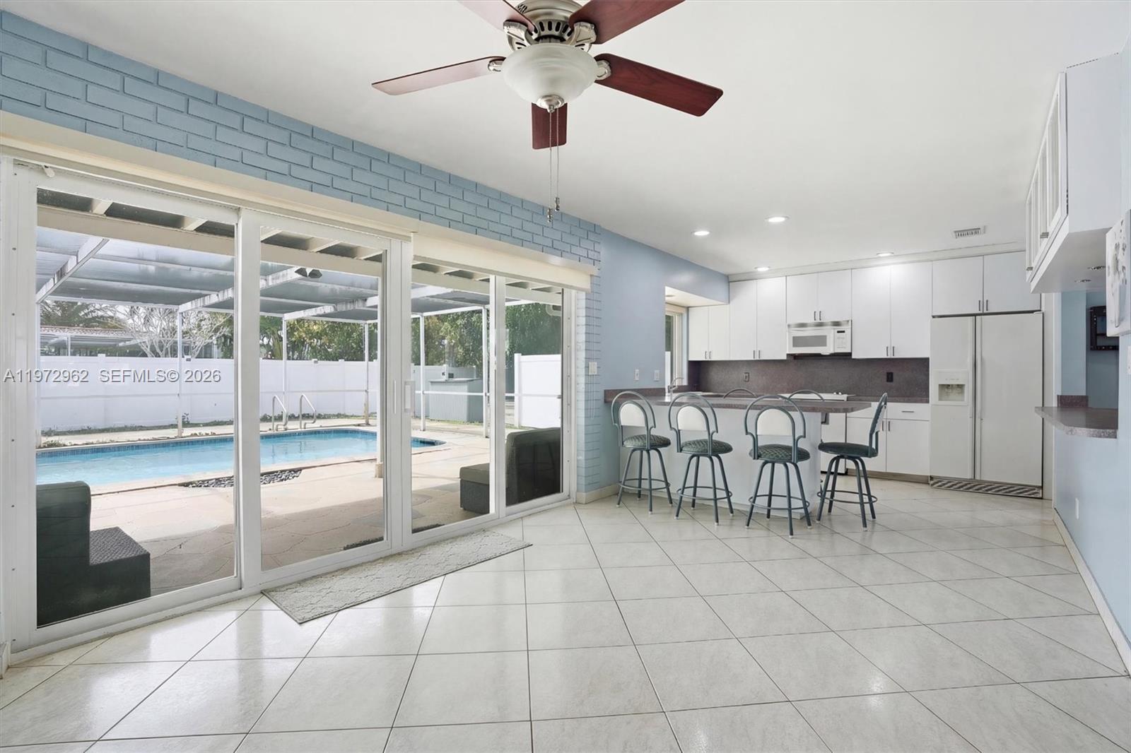 5518 McKinley Street Hollywood, FL 33021 - Photo 5 of 21 a dining hall with a dining table and chairs