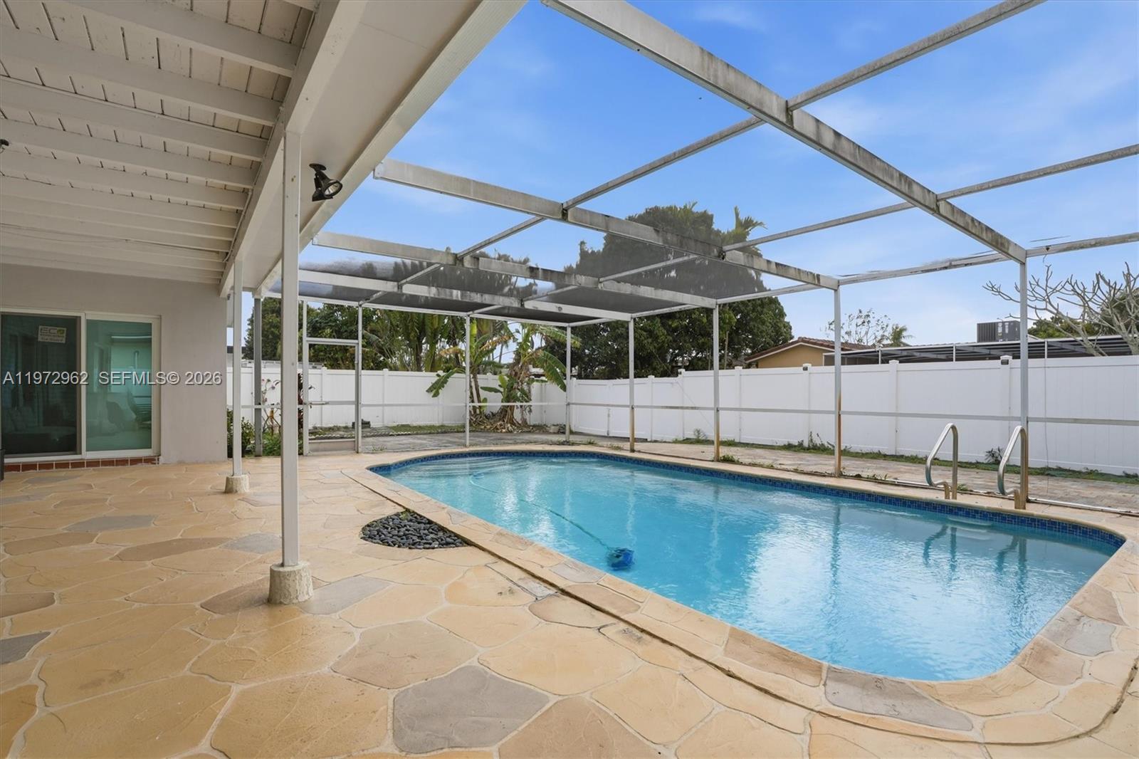 5518 McKinley Street Hollywood, FL 33021 - Photo 7 of 21 a view of a swimming pool with a patio