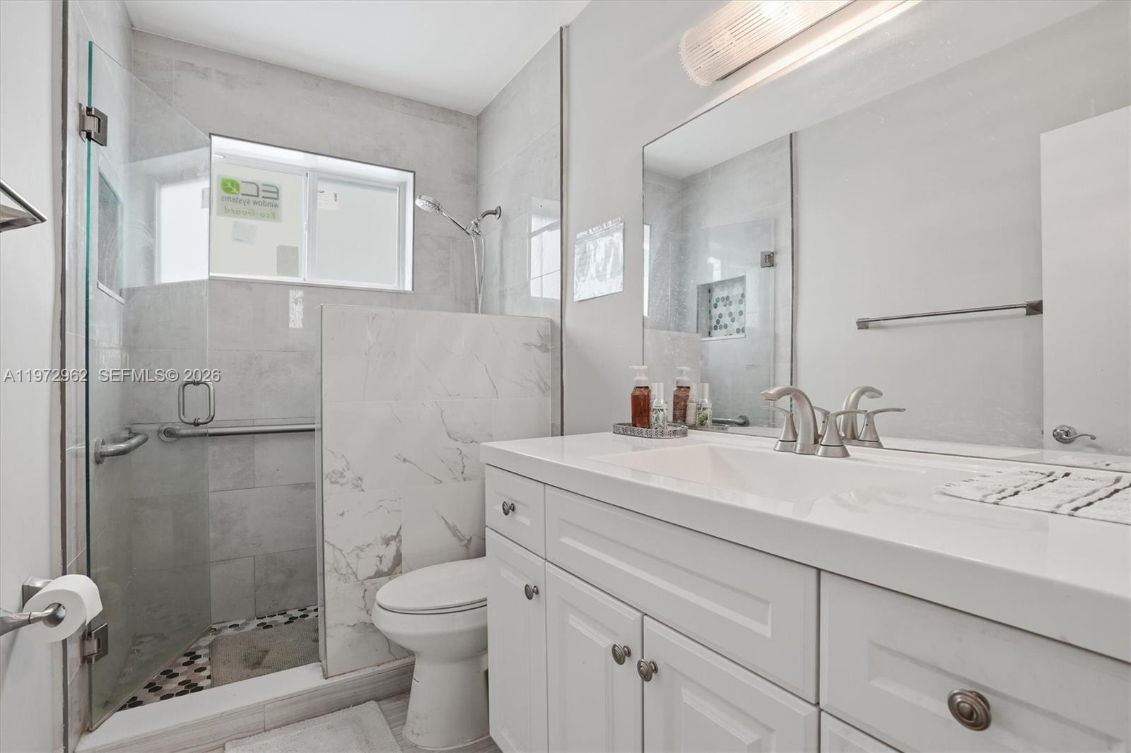 5518 McKinley Street Hollywood, FL 33021 - Photo 9 of 21 a bathroom with a sink a toilet and shower
