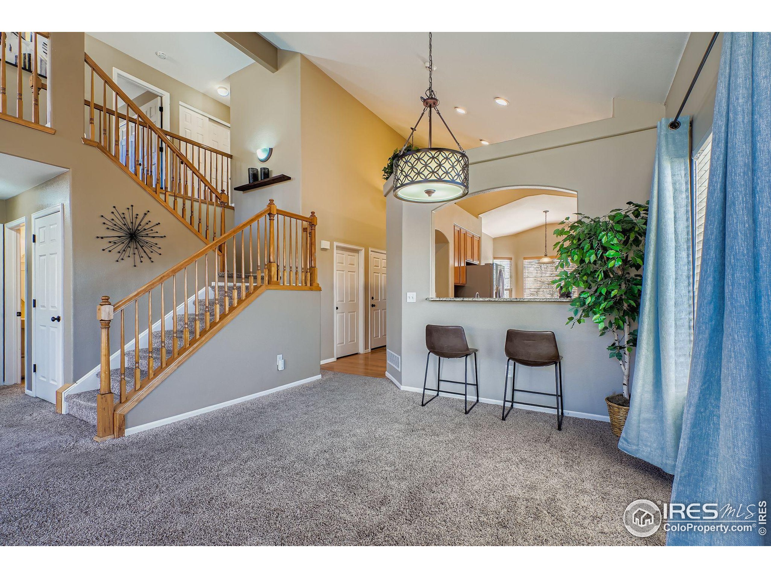 2011 Alpine Drive Erie, CO 80516 - Photo 5 of 21 a view of a livingroom with furniture stairs a chandelier