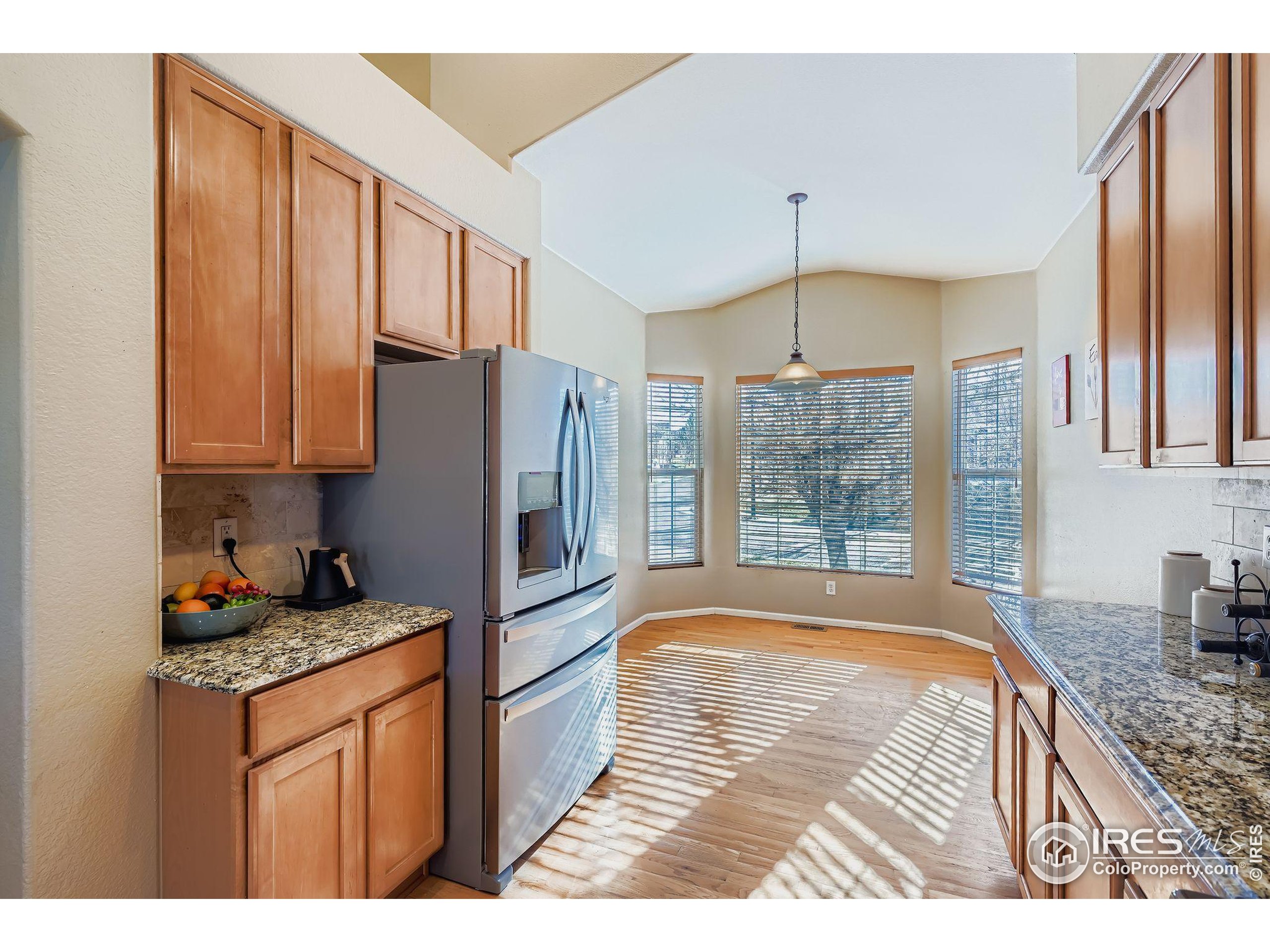 2011 Alpine Drive Erie, CO 80516 - Photo 8 of 21 a kitchen with refrigerator cabinets and wooden floor