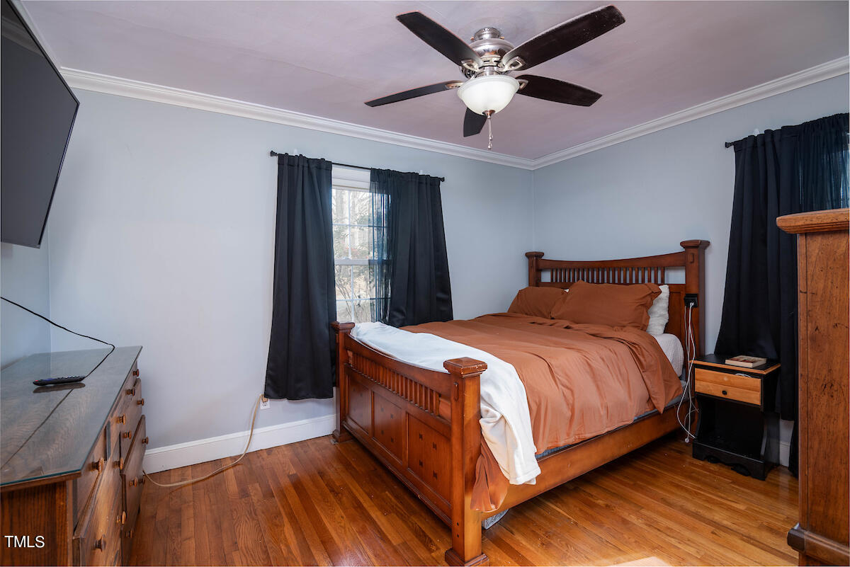 904 Frank Street Roxboro, NC 27573 - Photo 14 of 20 a bedroom with a bed and a ceiling fan