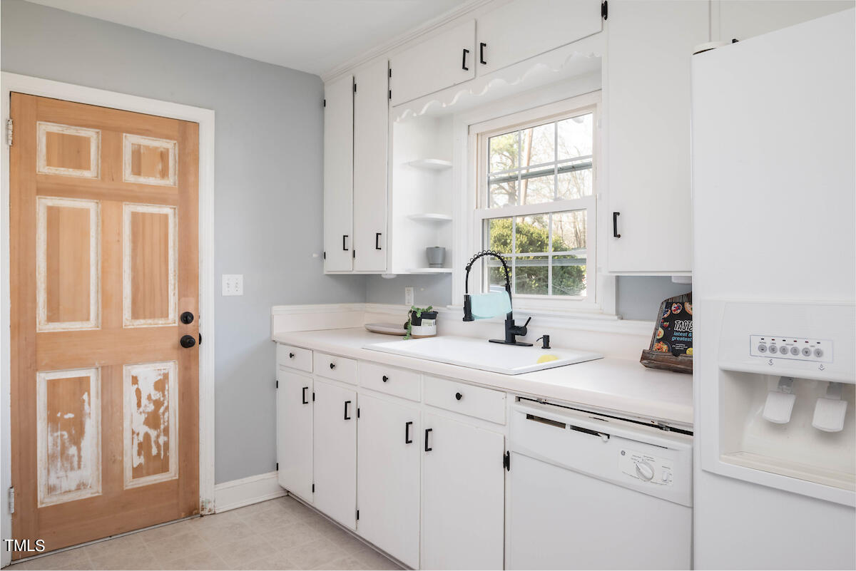 904 Frank Street Roxboro, NC 27573 - Photo 3 of 20 a kitchen with white cabinets and a window