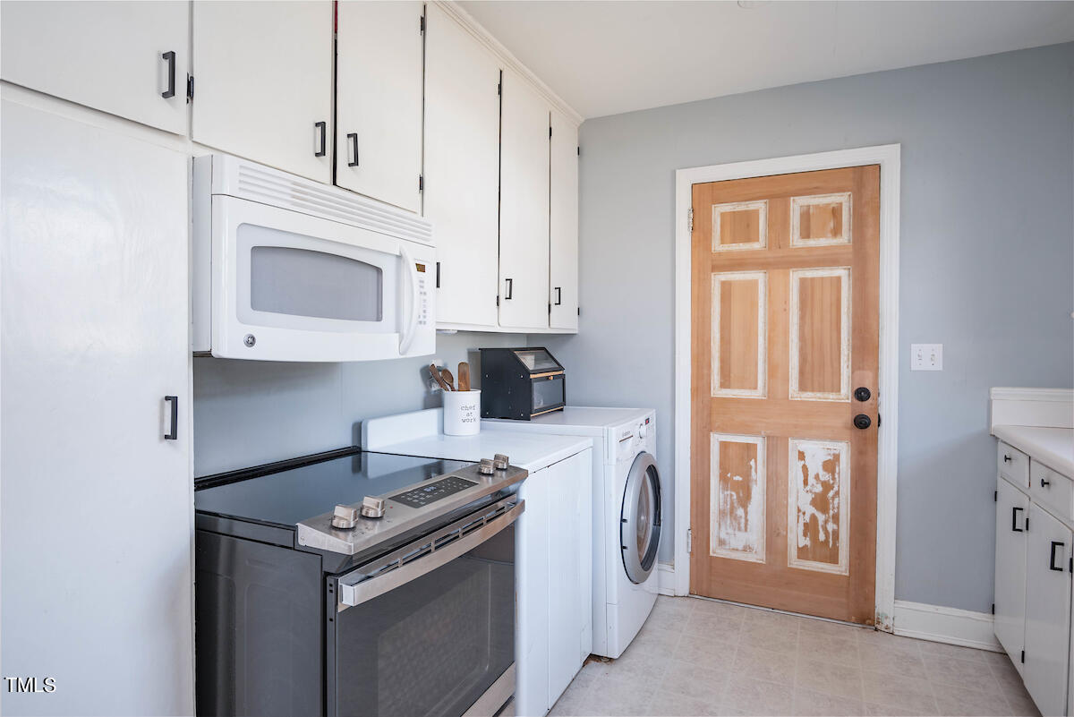 904 Frank Street Roxboro, NC 27573 - Photo 9 of 20 a kitchen with stainless steel appliances granite countertop a stove a refrigerator and a microwave